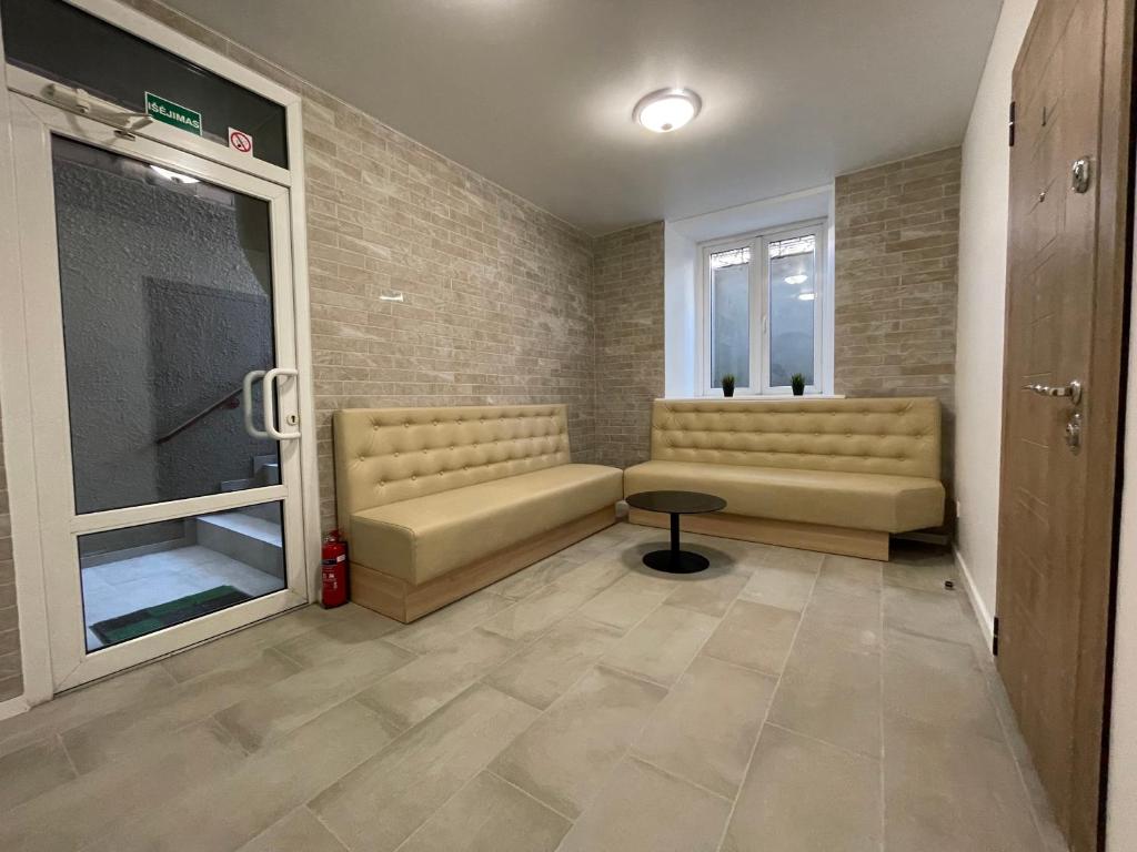 a waiting room with two couches and a window at Modern guest house in city center I Room 3 in Vilnius
