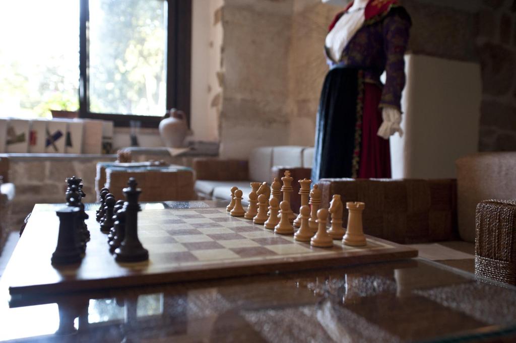 a chess board with chess pieces on a table at Nascar Hotel in Santa Maria Navarrese