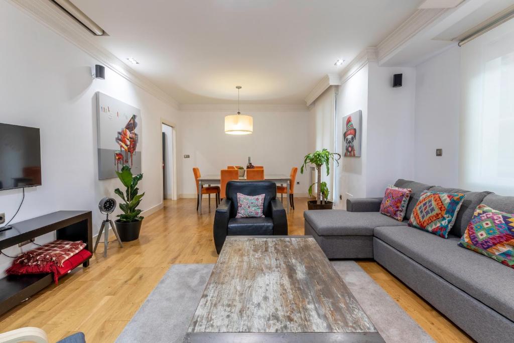 a living room with a couch and a table at Azkuna Comfort Bilbao in Bilbao