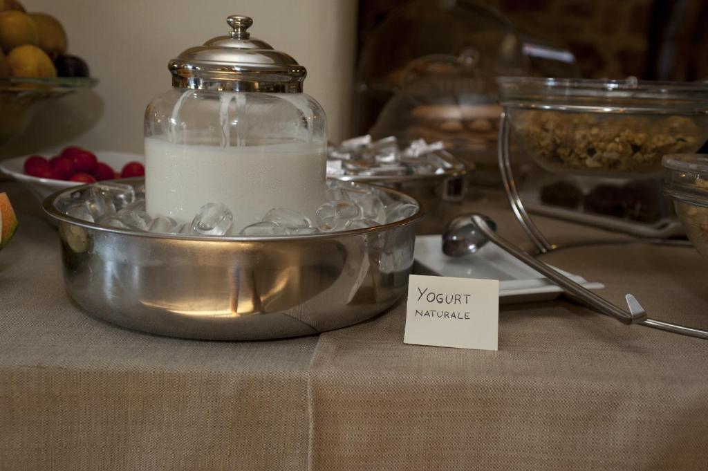 a bowl of milk in a jar on a table at Nascar Hotel in Santa Maria Navarrese