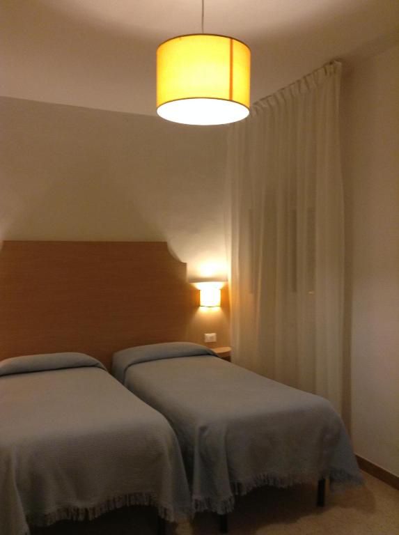 Postel nebo postele na pokoji v ubytování Albergo Giugni