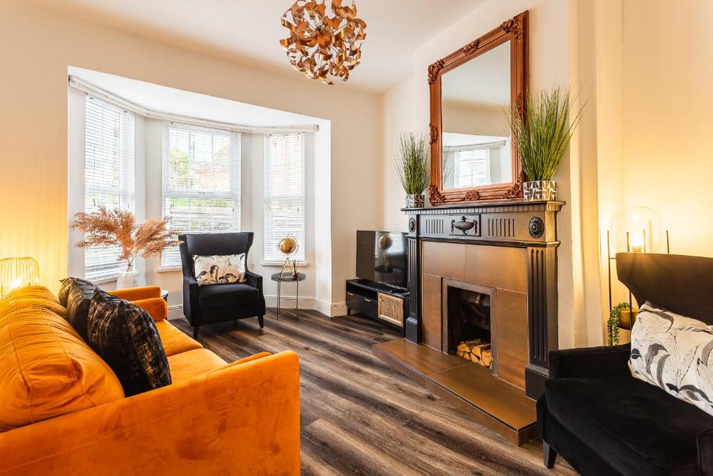 a living room with a couch and a fireplace at The Crescent Townhouse in Lisburn