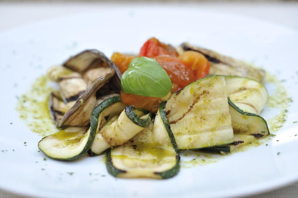 a plate of food with potatoes and vegetables on it at Nascar Hotel in Santa Maria Navarrese