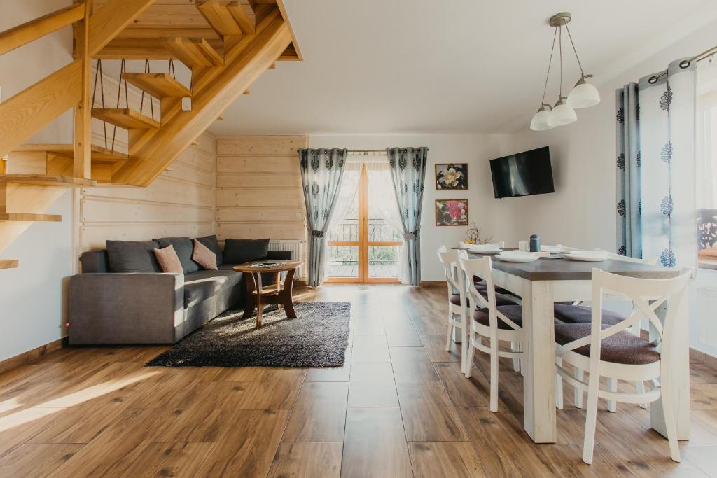 a kitchen and living room with a table and a couch at Chatka u Stanka in Biały Dunajec