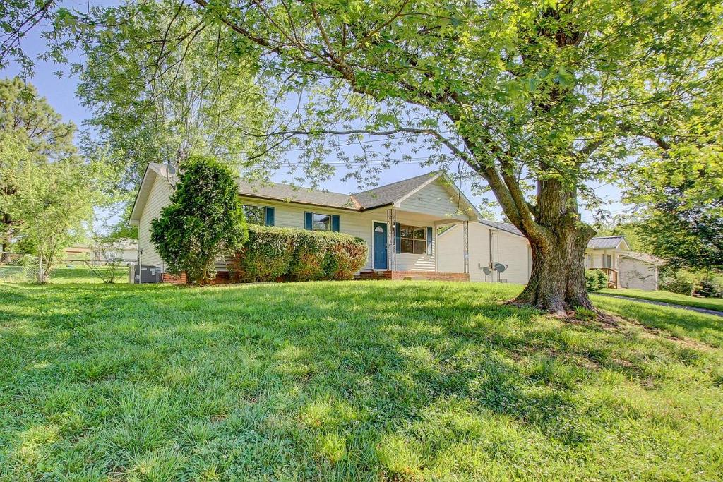 a house with a tree in the yard at Beautiful home in a nice place in Clarksville