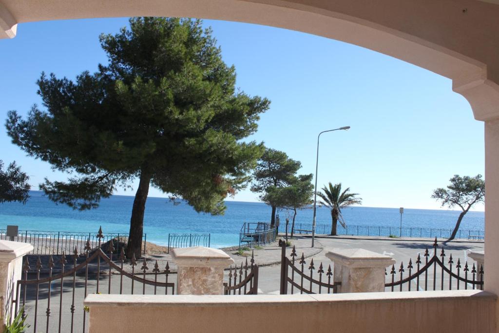 a view of the beach from the balcony of a building at On The Beach in Mazzeo