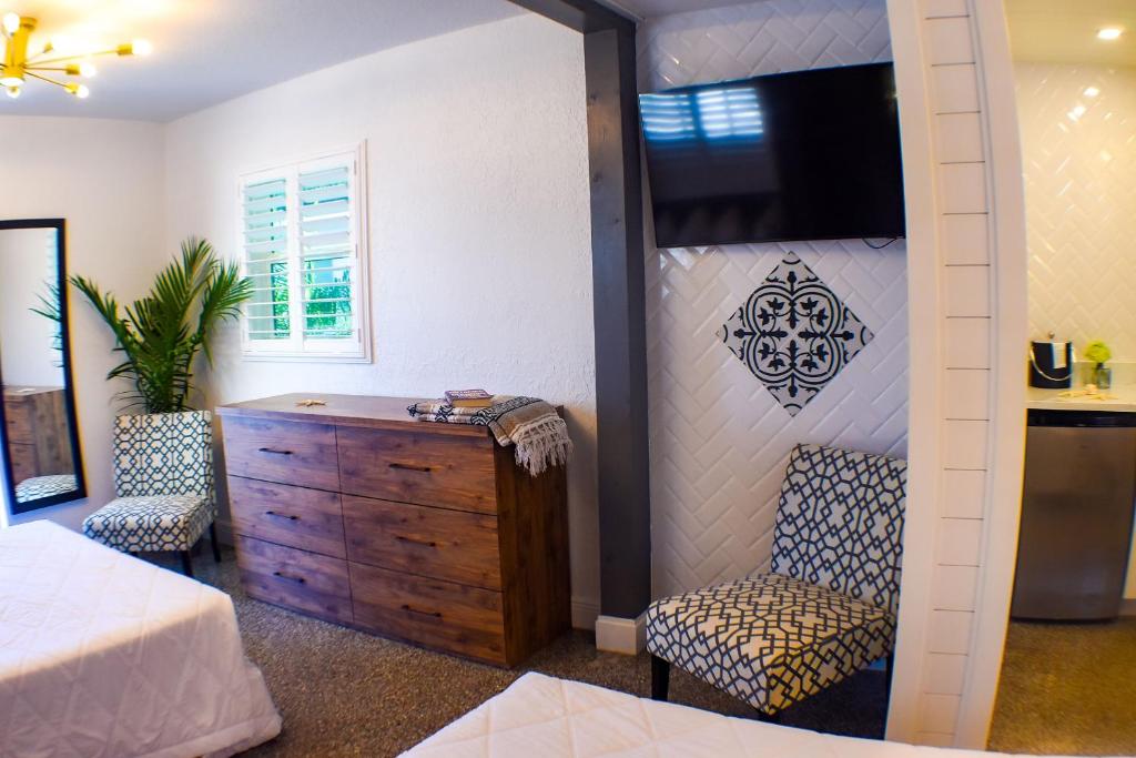 a bedroom with a bed and a dresser and a tv at Devon Shores in Clearwater Beach
