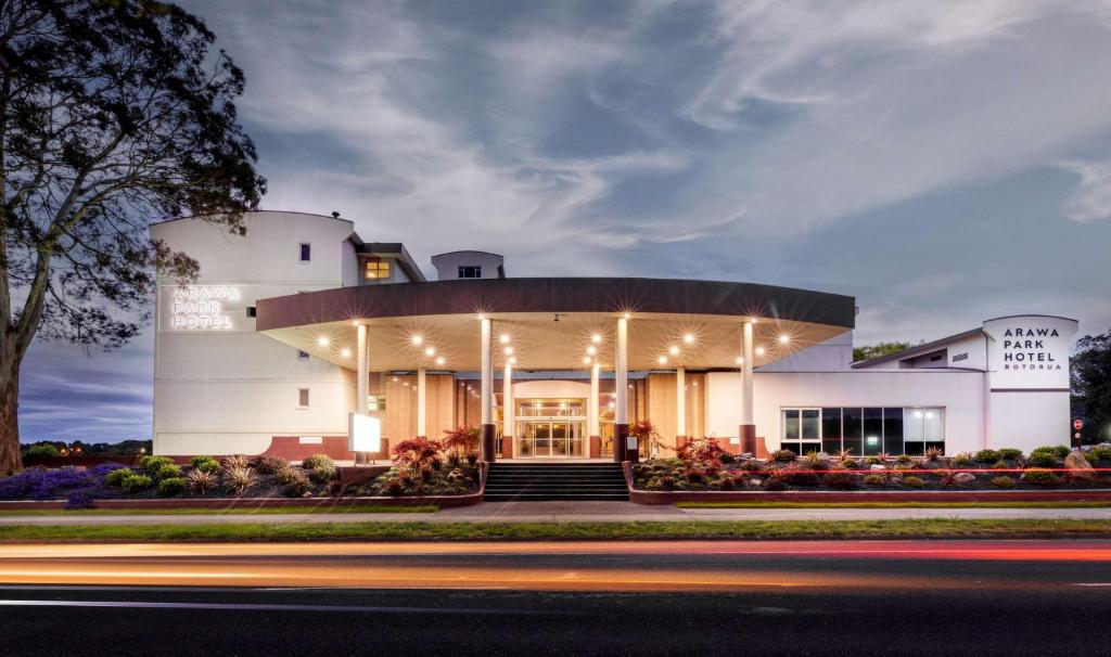 un gran edificio blanco con luces encendidas en Arawa Park Hotel, Independent Collection by EVT en Rotorua