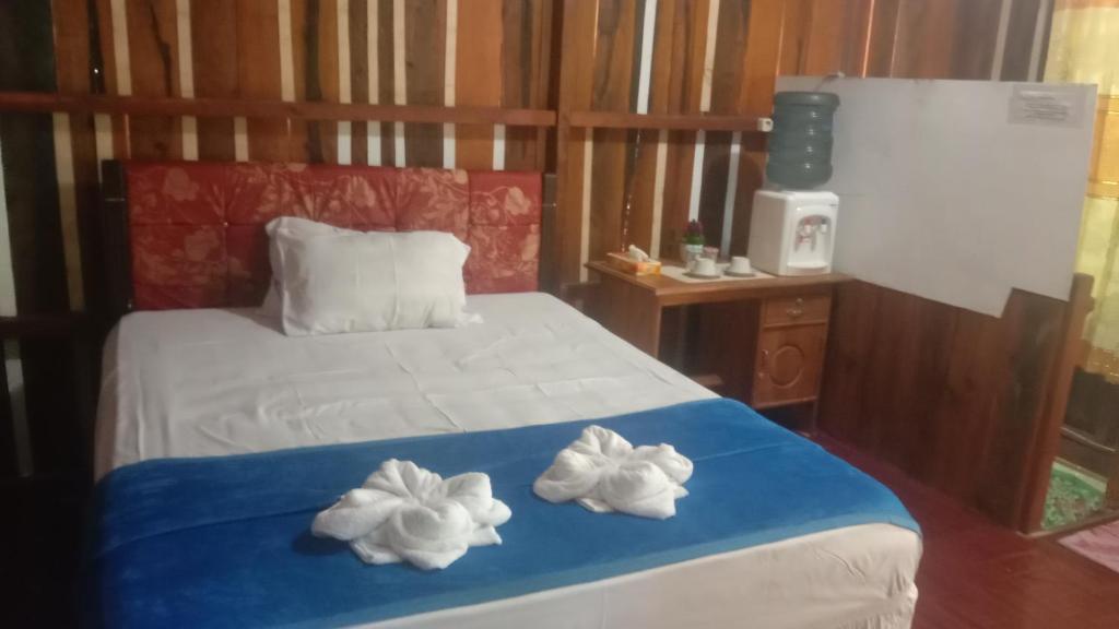 a bedroom with a bed with two towels on it at Yohana Cottage in Tual