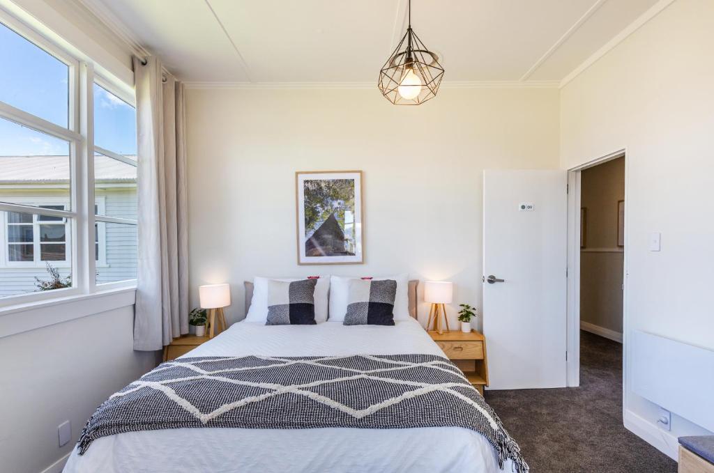 a bedroom with a bed and a window at Lake Maraetai Lodge in Mangakino