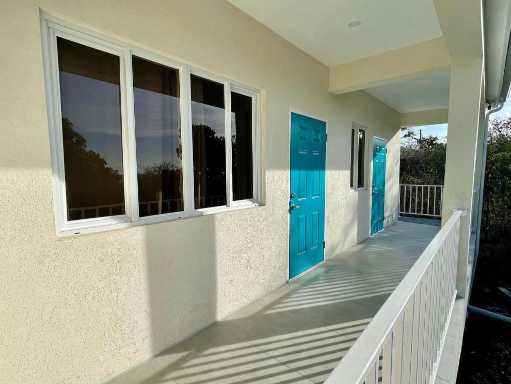 a house with blue doors and a porch at Hilltop Condos in Gros Islet