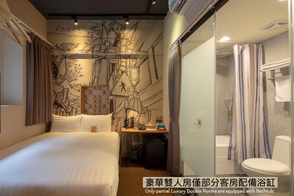 a bedroom with a white bed and a bathroom at Cho Hotel in Taipei