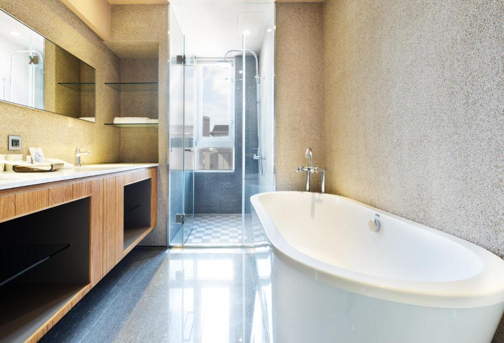 a bathroom with a large white tub and a shower at Home Hotel in Taipei