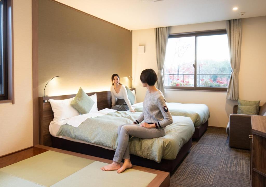 Postel nebo postele na pokoji v ubytování HOTORI no HOTEL BAN