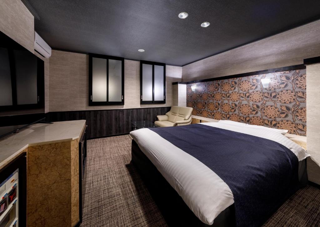 Postel nebo postele na pokoji v ubytování HOTEL HanaBi 長良の湯 -大人専用-