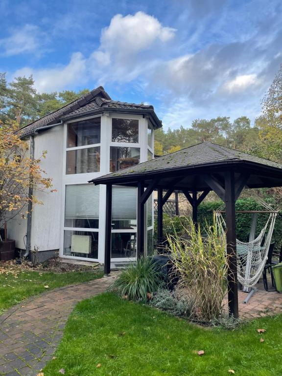 a house with a gazebo in the yard at Ferienhaus Weniger in Bad Saarow