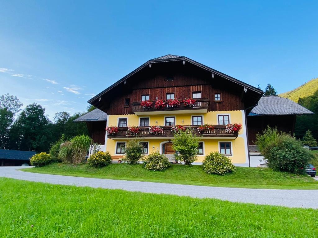 a large building with flowers in front of it at Leitenhof in Hintersee