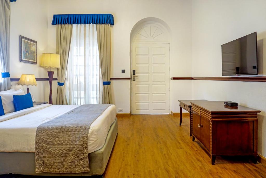 Postel nebo postele na pokoji v ubytování Citrus Chambers Mahabaleshwar