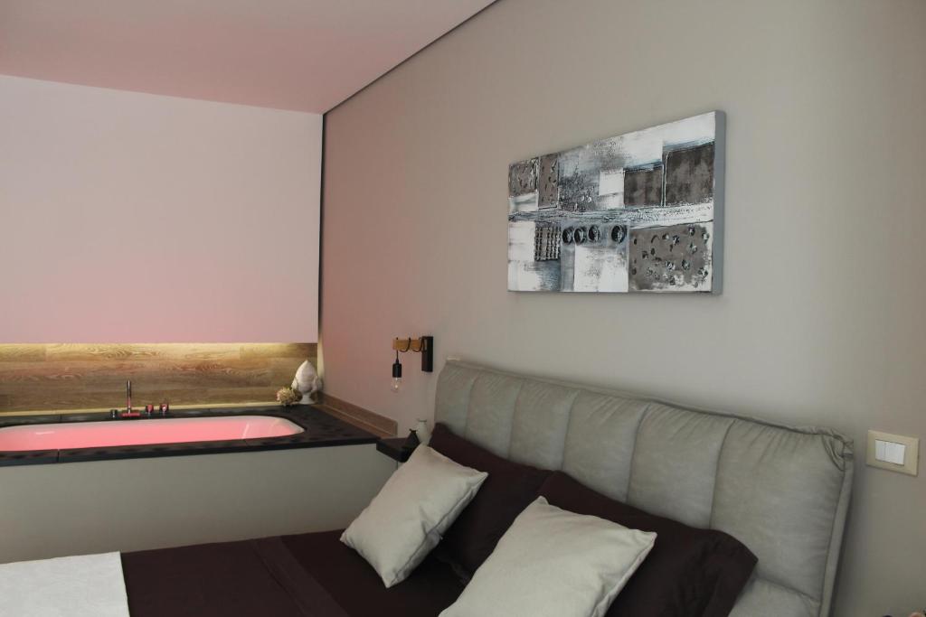 a bedroom with a bed and a bath tub at Le casette in Monopoli