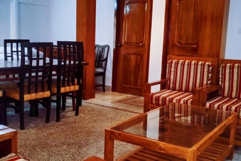 a living room with a dining room table and chairs at Ashiana Serviced Apartment in Sylhet