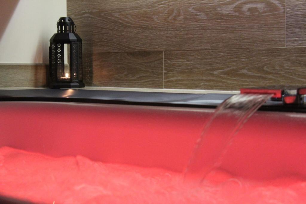 a red bath tub with a brush in it at Le casette in Monopoli