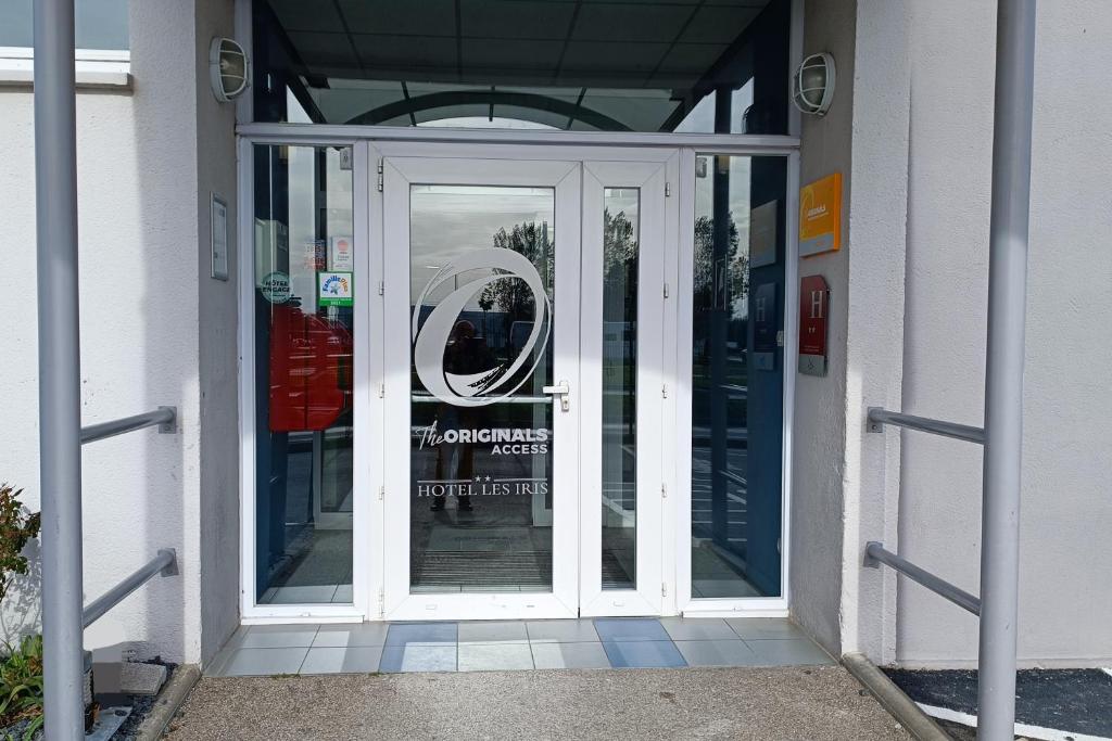 an entrance to a building with a revolving door at The Originals Access, Hôtel les Iris, Berck-sur-Mer in Berck-sur-Mer