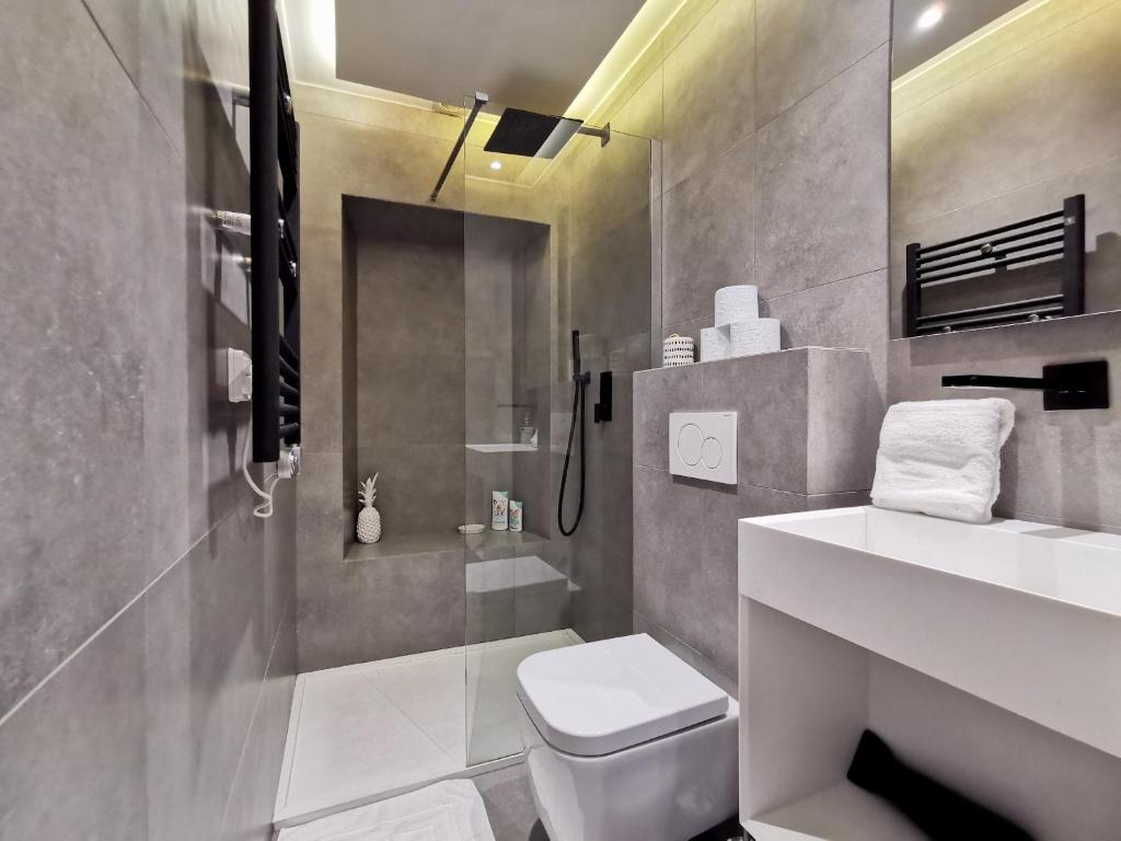 a bathroom with a toilet and a sink and a shower at Le PETIT BALCON by Booking Guys in Nice