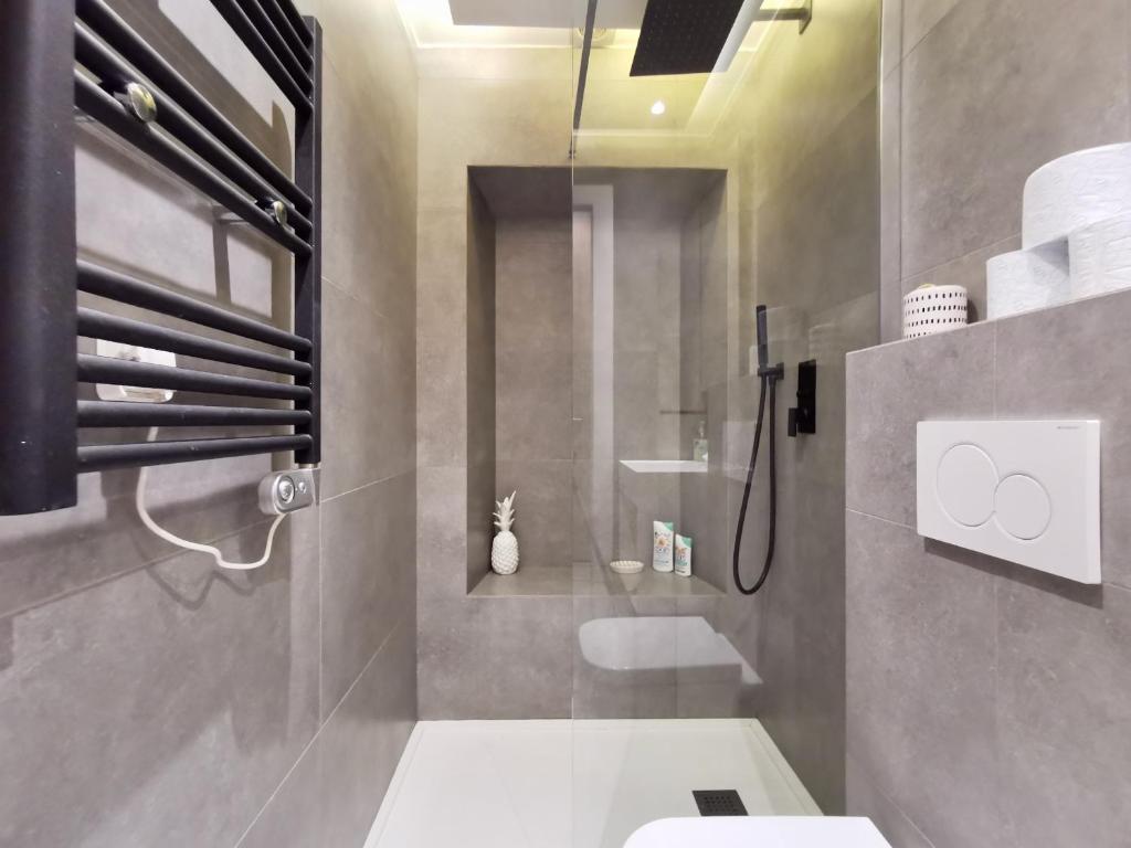 a bathroom with a shower and a toilet in it at Le PETIT BALCON by Booking Guys in Nice