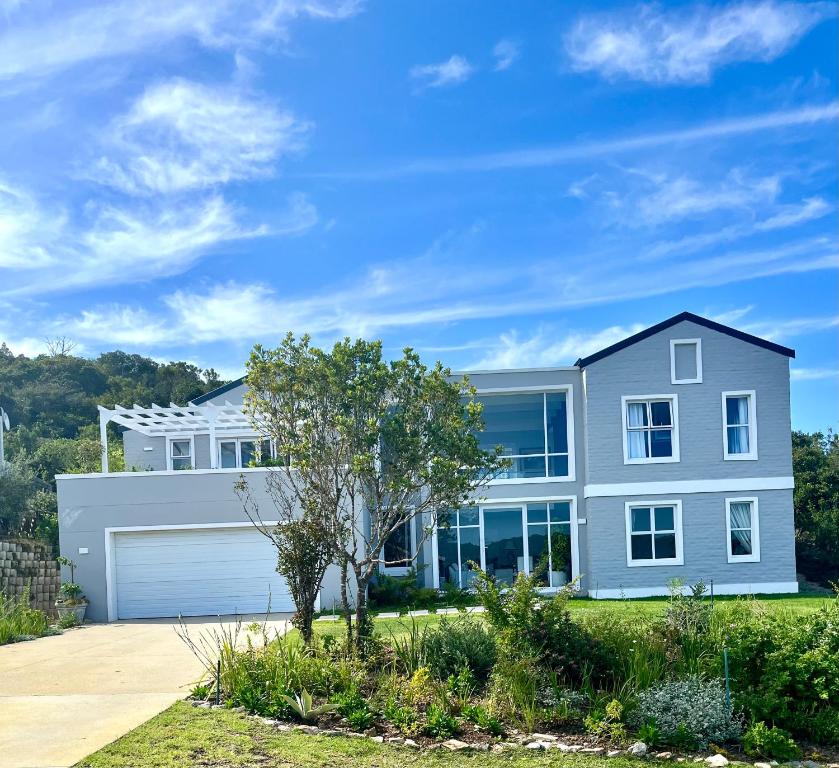 a large house with a garage at The Pijper House - Brackenridge Eco Estate Plettenberg Bay in Plettenberg Bay