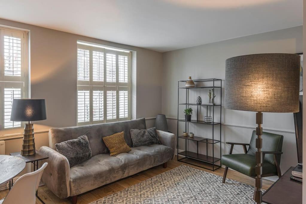a living room with a couch and a table at Nelson Crescent East : Modern one bedroom basement apartment in central location in Kent