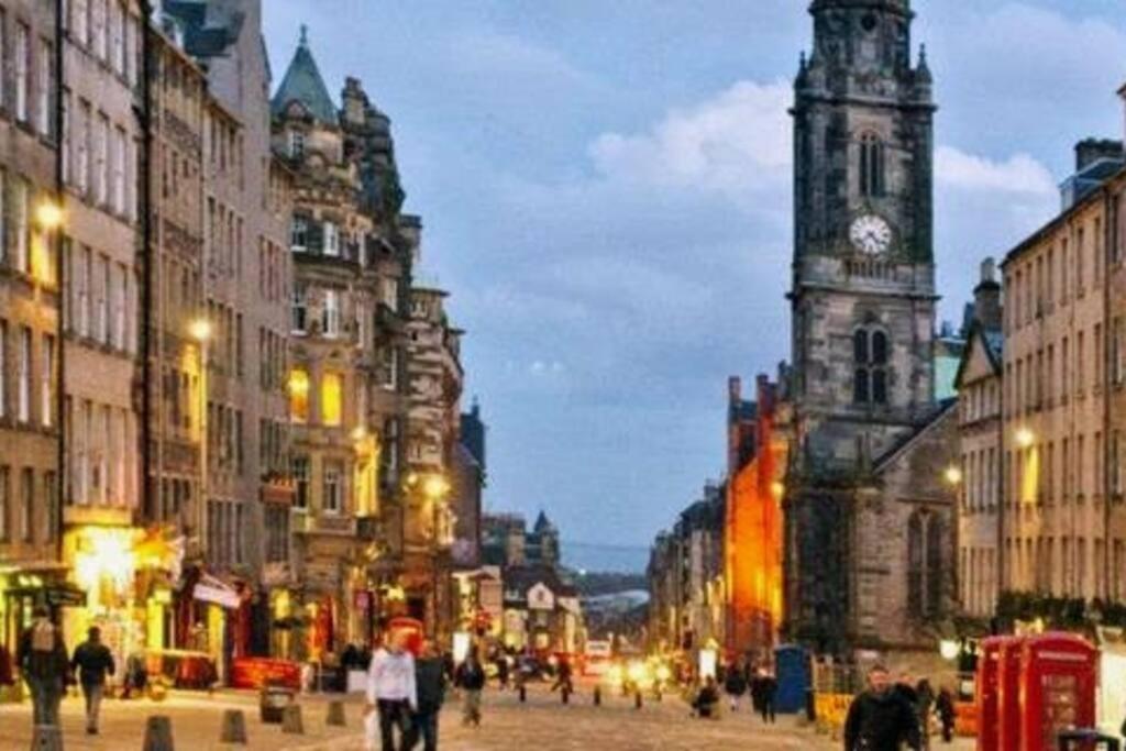 a city street with a clock tower and people walking at *Amazing Location!*In heart of the City. 2BR & Cot in Edinburgh