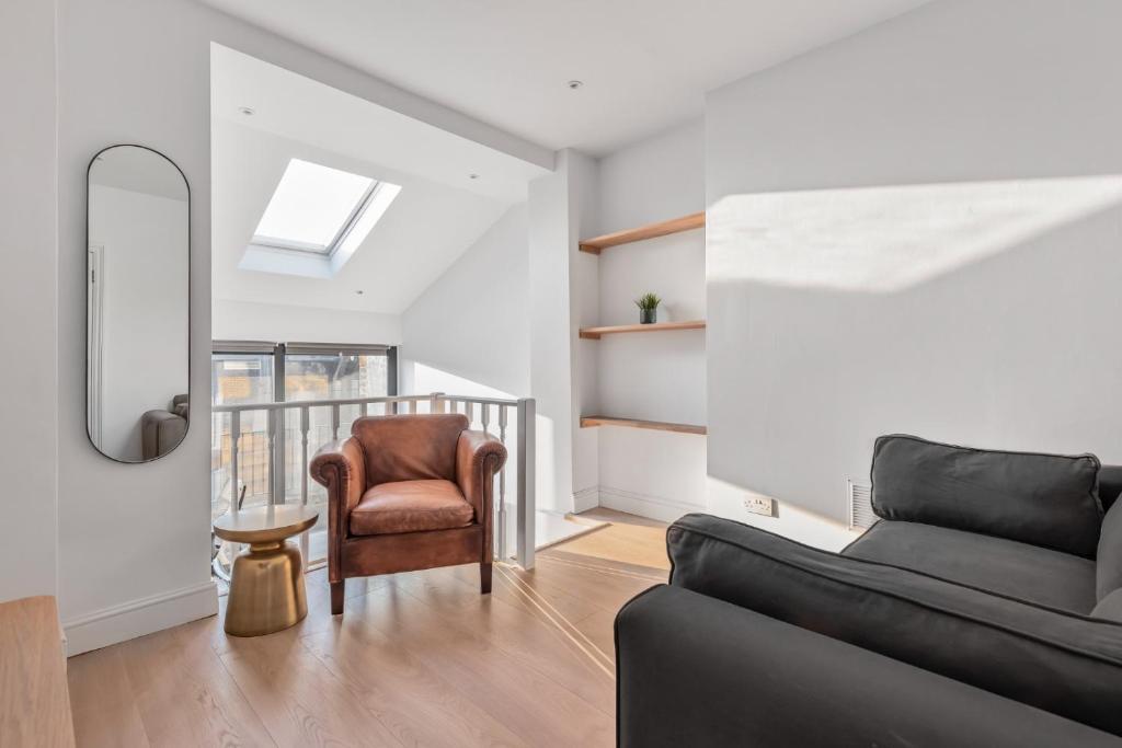 a living room with a couch and a chair at Central London-Modern Contemporary Flat in London
