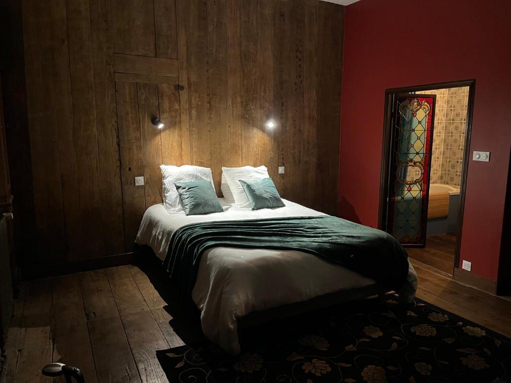 Mercier de Montigny - Les Chambres du Beffroi - SPA et Massage في فوجير: غرفة نوم مع سرير ونافذة زجاجية ملطخة