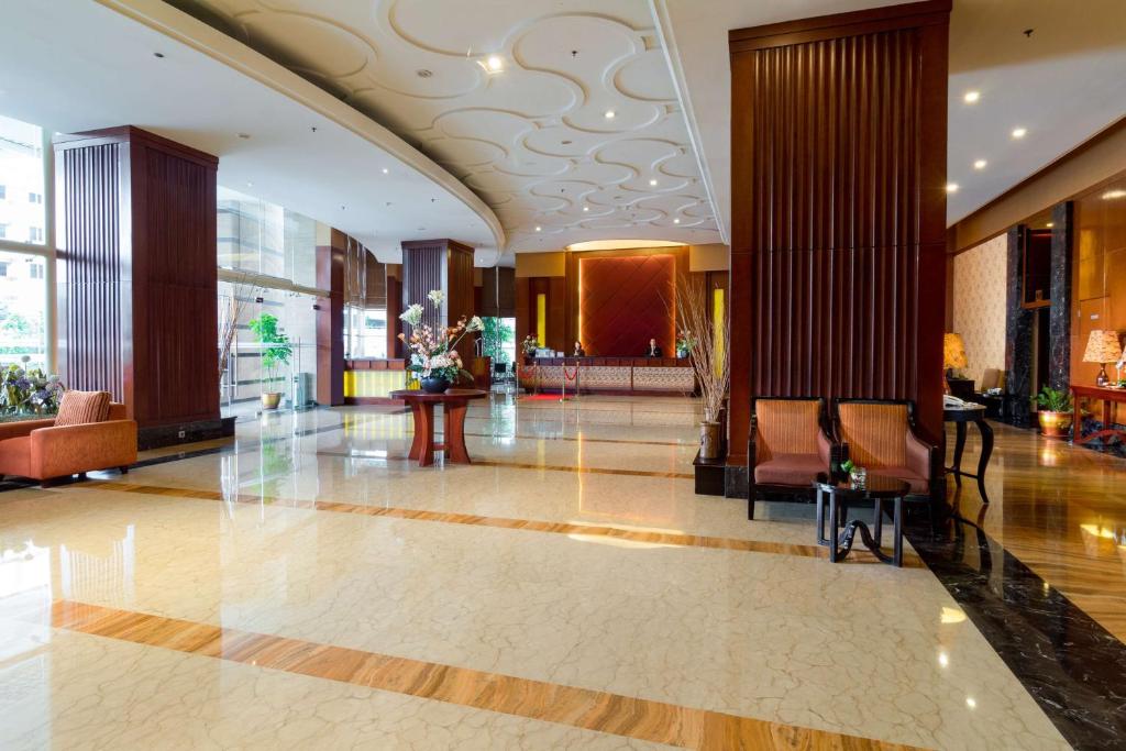 a lobby with chairs and tables in a building at Best Western Green Hill Hotel in Yangon