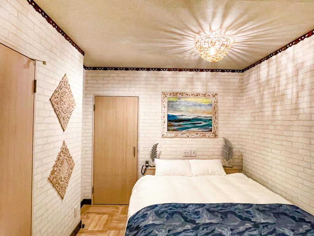 Postel nebo postele na pokoji v ubytování Hotel BaliBali 伊勢佐木