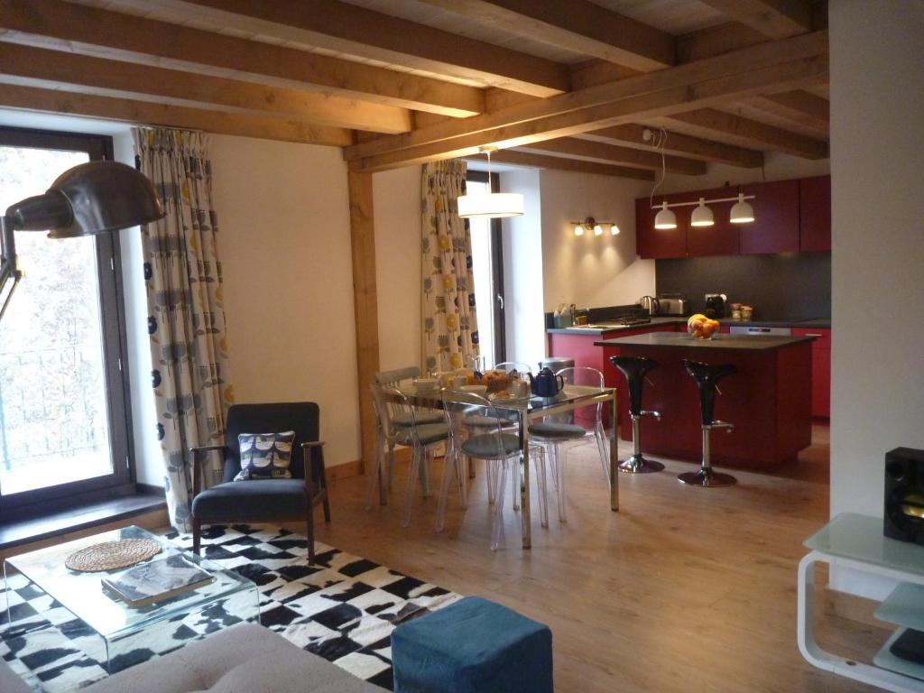 Appartement Le Hibou في كورشوفيل: مطبخ وغرفة طعام مع طاولة وكراسي