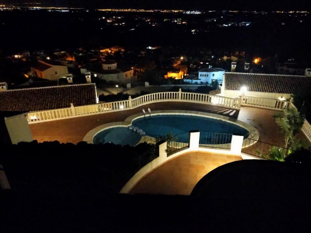 a view of a swimming pool at night at Casa Rafol in Monte Pego