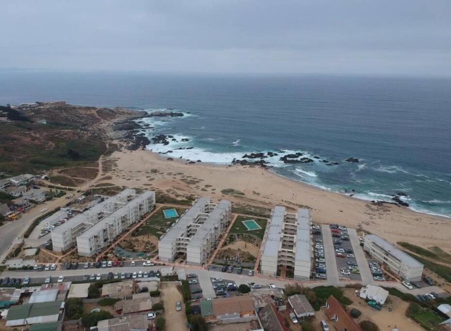 an aerial view of a beach with white buildings at A pasos del mar Lugar ideal para descansar in El Tabo