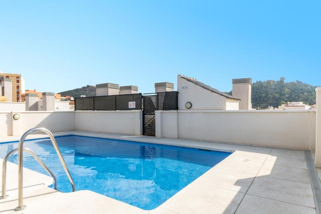 a swimming pool on the roof of a building at -MalagaSunApts- Stylish City Centre Pool&Parking in Málaga