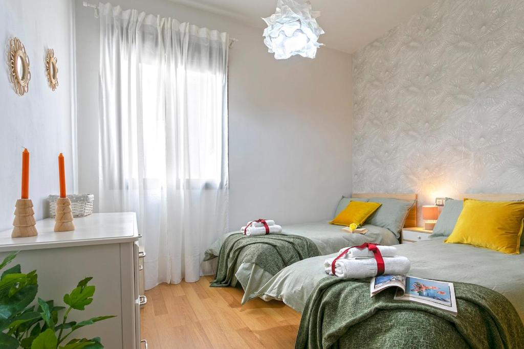 A bed or beds in a room at -MalagaSunApts- Central FreeParking RooftopPool