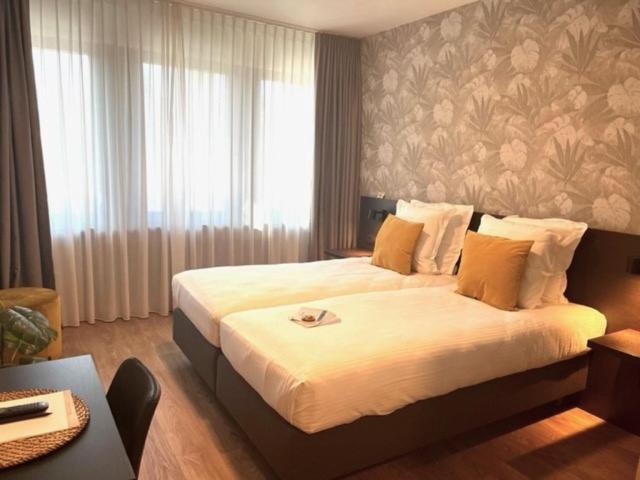 Postel nebo postele na pokoji v ubytování Bloomhotel