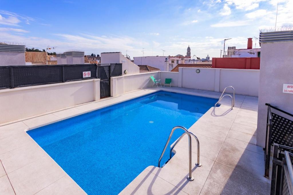 a swimming pool on the roof of a building at -MalagaSunApts- Rooftop Pool in Málaga