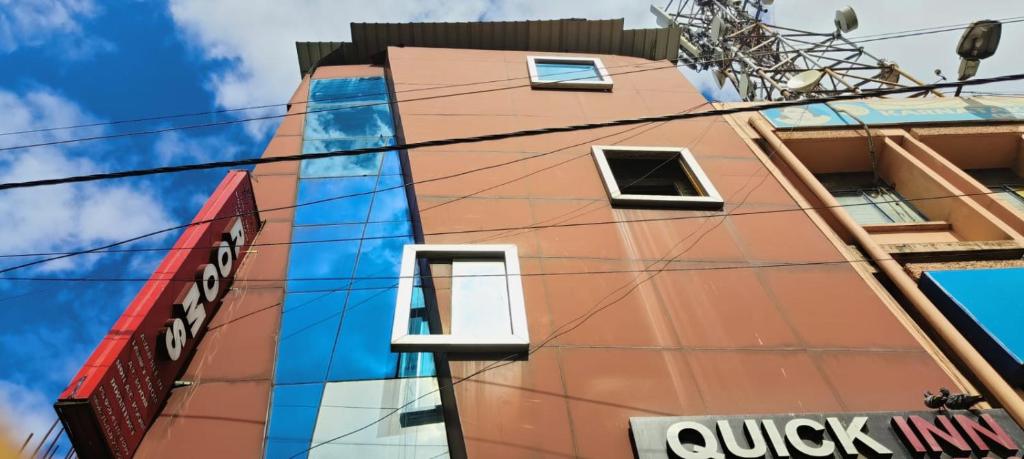 a tall orange building with windows on the side of it at Hotel Quick Inn By WB Inn in Bangalore