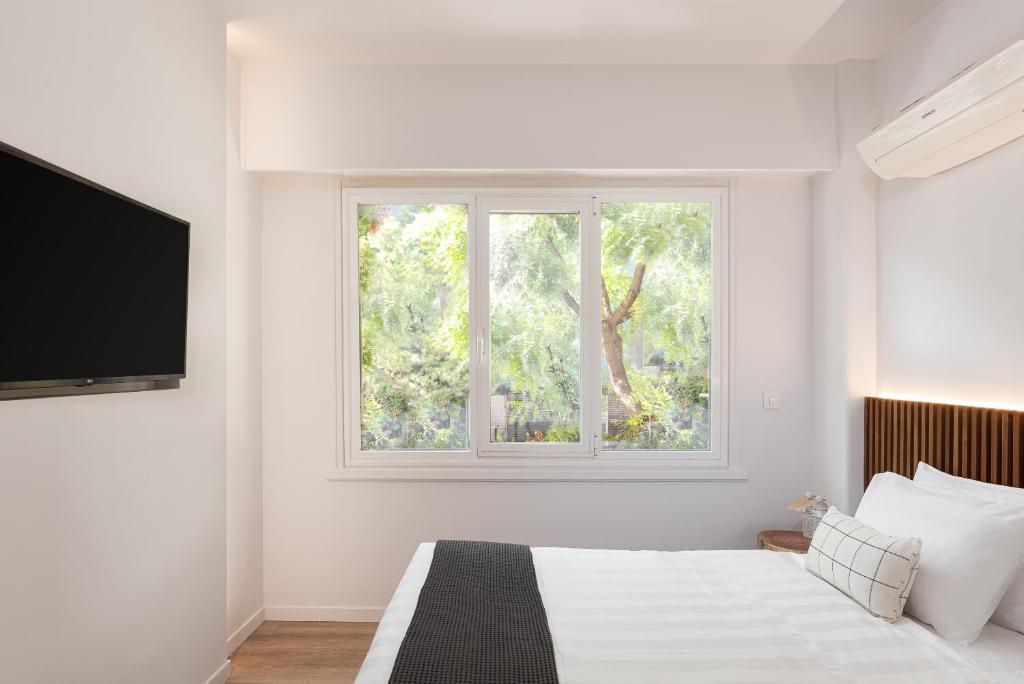 Posteľ alebo postele v izbe v ubytovaní Acropolis Holmes Residence