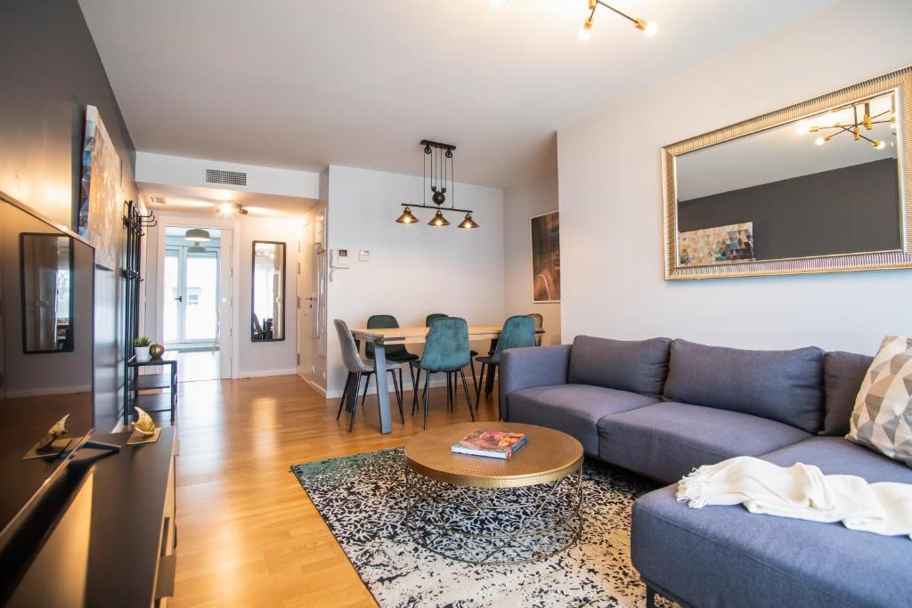 サン・アドリア・デ・ベソスにあるTendency Apartments Forumのソファとテーブルのあるリビングルーム