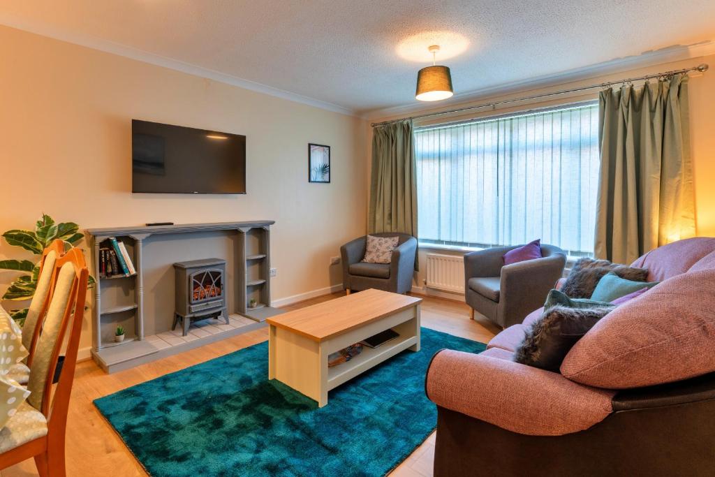 a living room with a couch and a fireplace at Finest Retreats - Southern Lea in Burnham on Sea