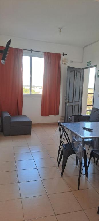 a living room with a table and a couch at Sol y Malbec Departamentos in Guaymallen