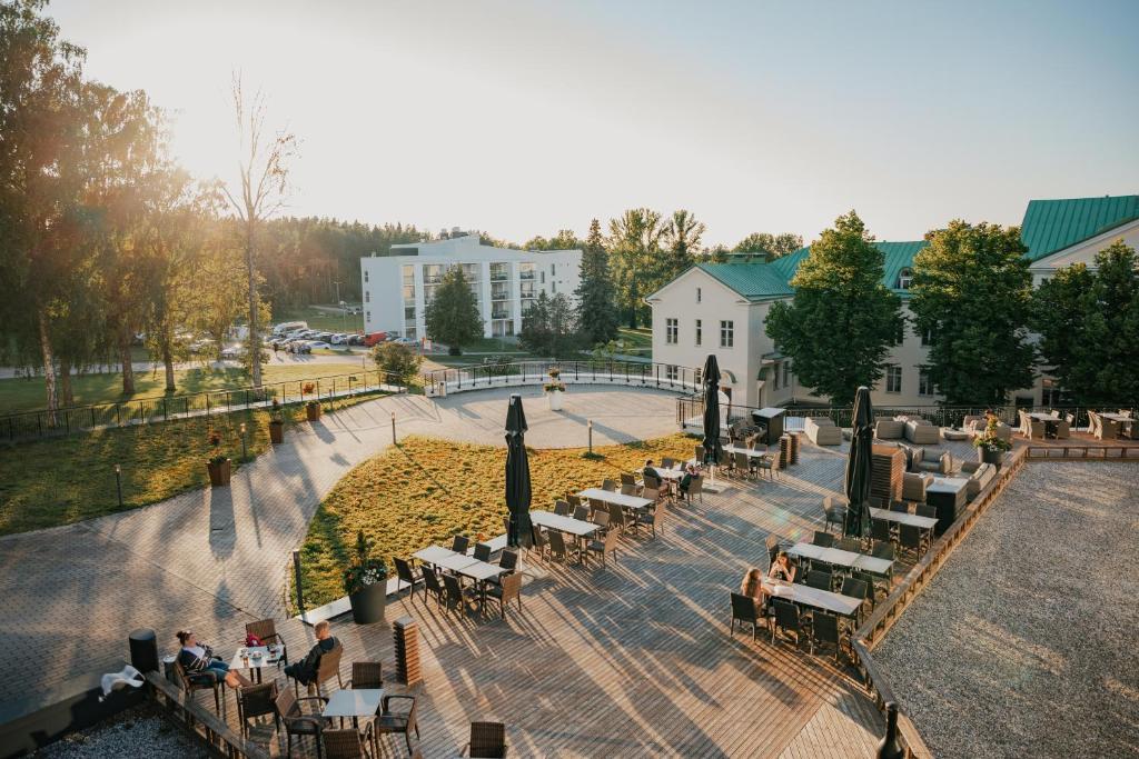 a group of people sitting at tables in a park at Holiday Club Saimaa Superior Apartments in Imatra