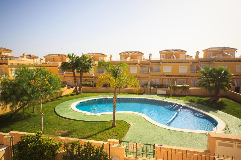 a large swimming pool in front of a building at Holiday home Punta Prima in Torrevieja