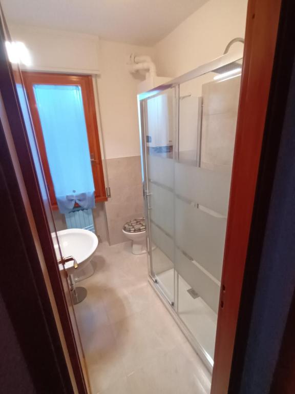 a bathroom with a shower and a toilet and a sink at Caletta Beach in Castiglioncello